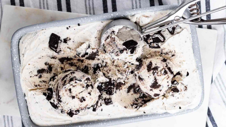 White ice cream in a loaf tine with crushed oreo cookies.