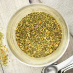 A green-flecked spice mix in a jar.