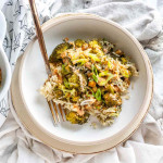 Broccoli, rice, and chickpeas in a bowl topped with green onions.