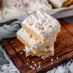 Stacked cookie squares with sprinkles on them.