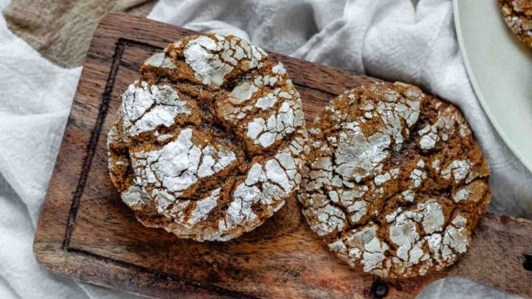 Brown crinkle cookies with powdered sugar topping.