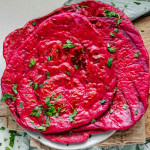 Pinky red flatbread on a plate.