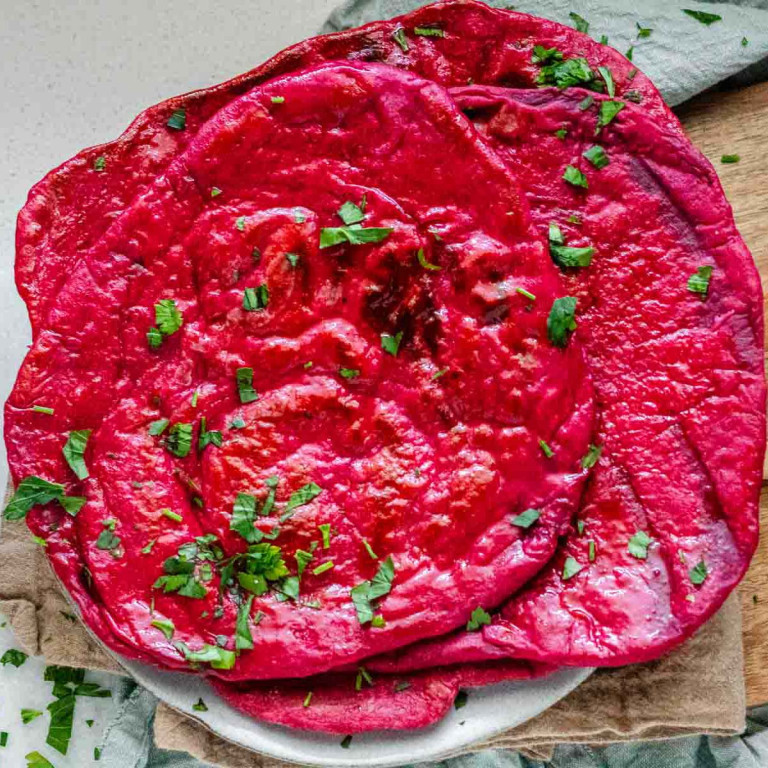 Pinky red flatbread on a plate.