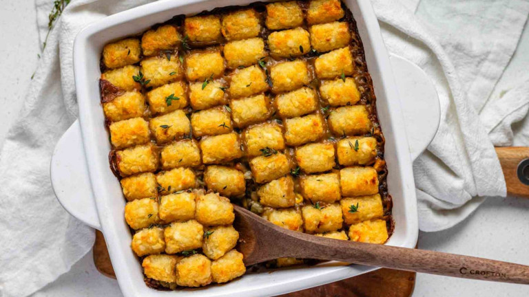 A casserole dish with the topping of baked tater tots.