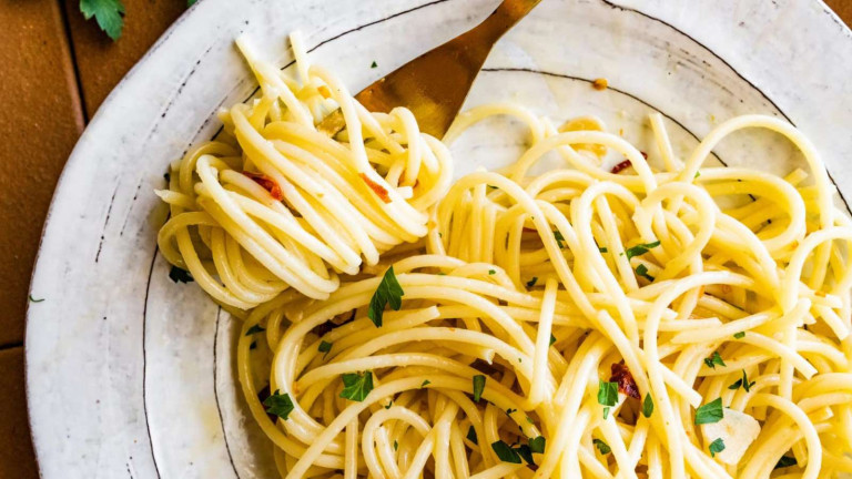 Pasta swirled around a fork on a plate.