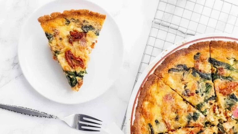 A breakfast casserole in a pie plate with a slice on a plate.