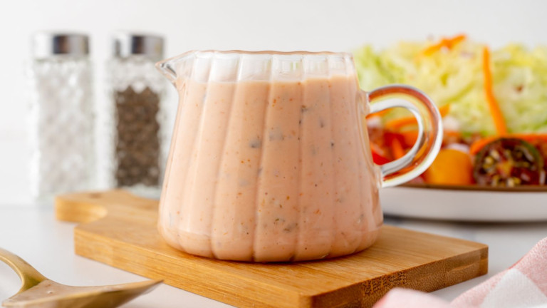 A jar of light orange sauce.
