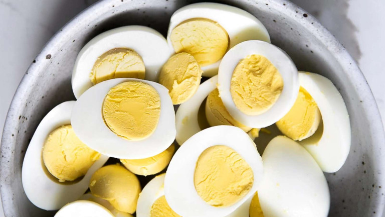 Halved hard boiled eggs in a bowl.