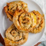 Baked golden pastry swirls topped with sesame seeds.