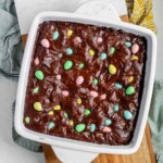 Brownies with mini eggs in a white baking dish.