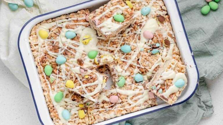 Rice Krispies treats in a pan, with mini eggs on top.