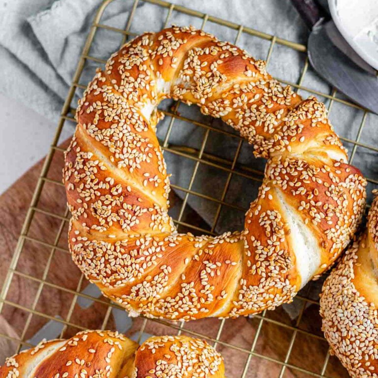 A golden brown round baked good coated in sesame seeds.