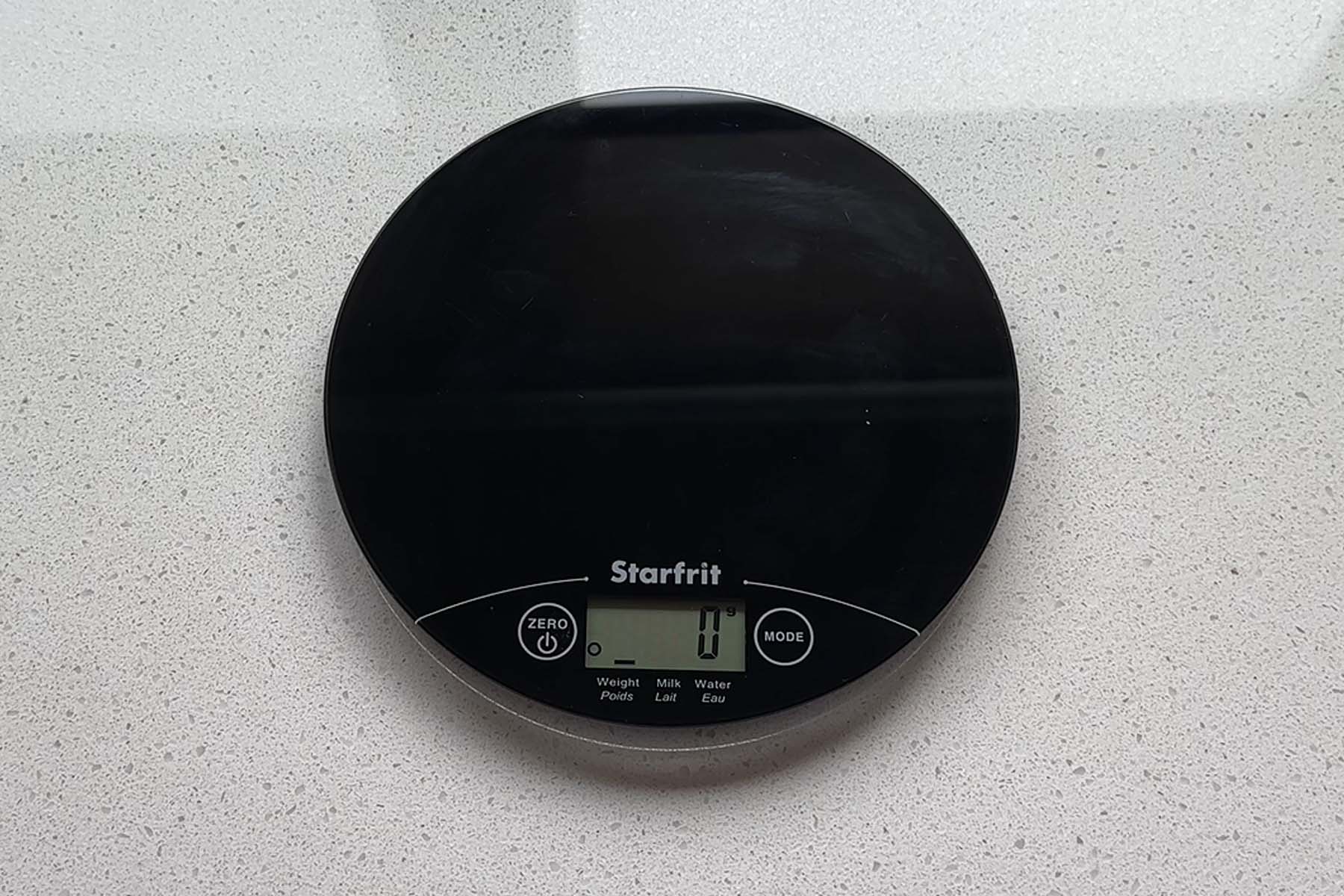 A digital kitchen scale that reads 0g.