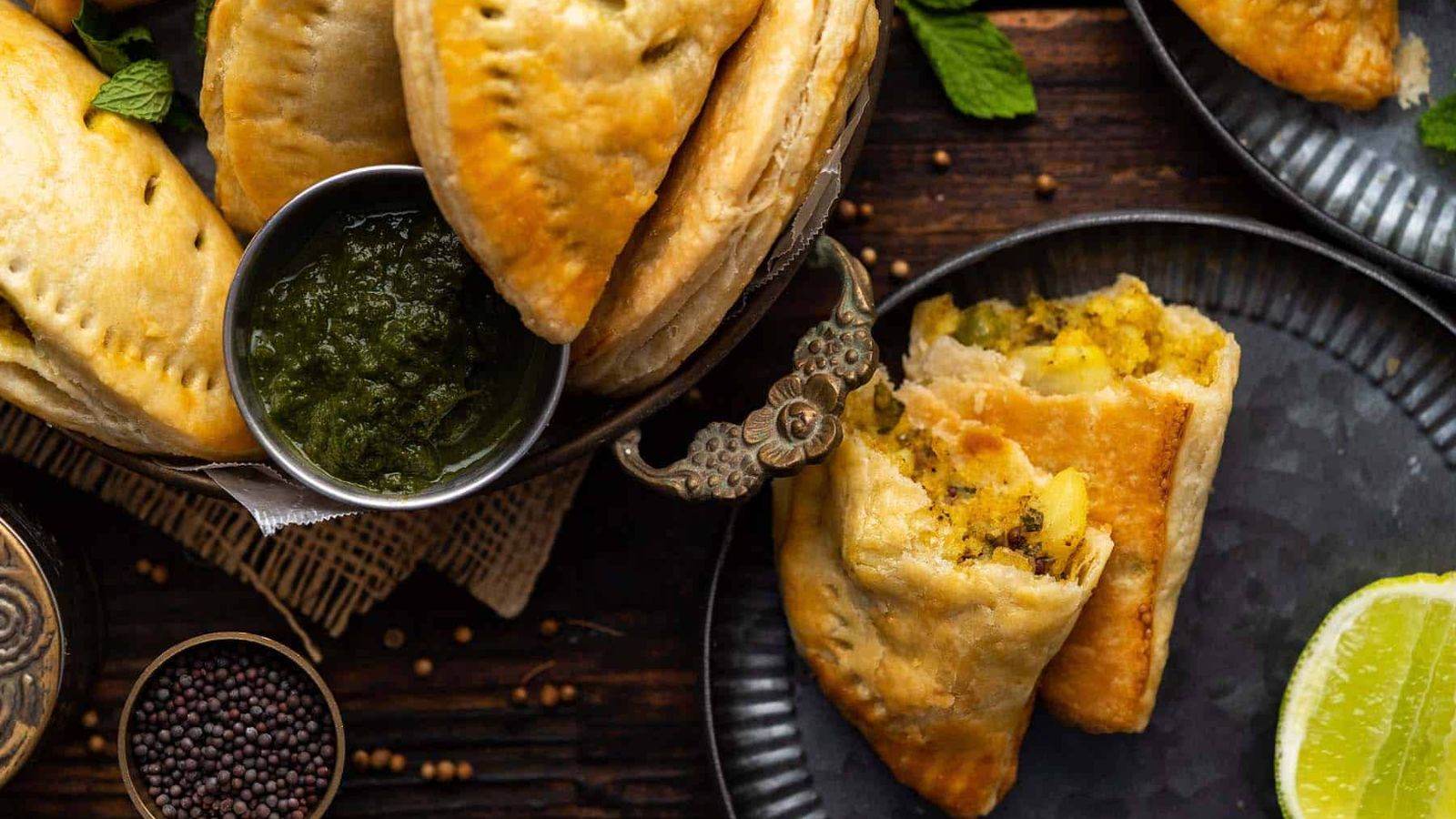 Puff pastry appetizers with one cut in half on a plate.