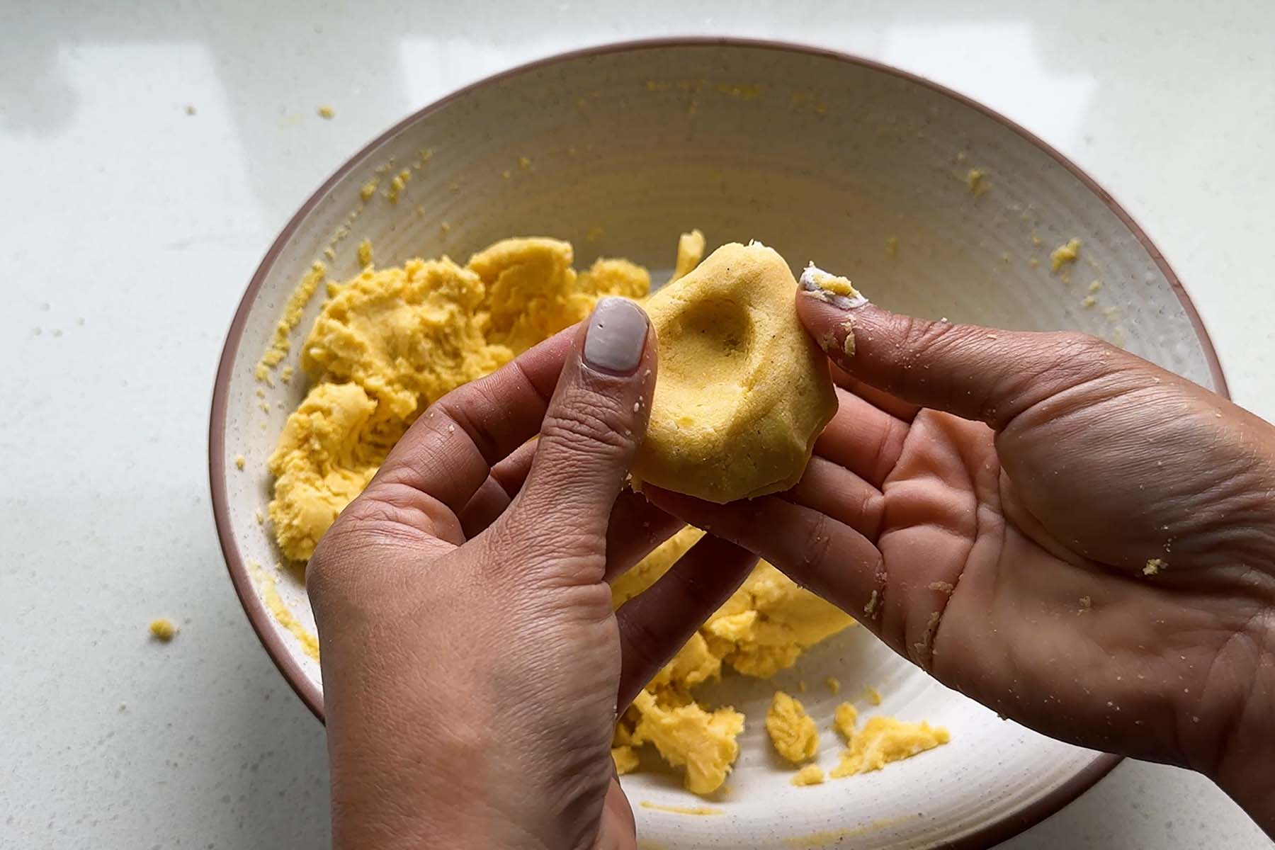 Corn dough is molded by hand.