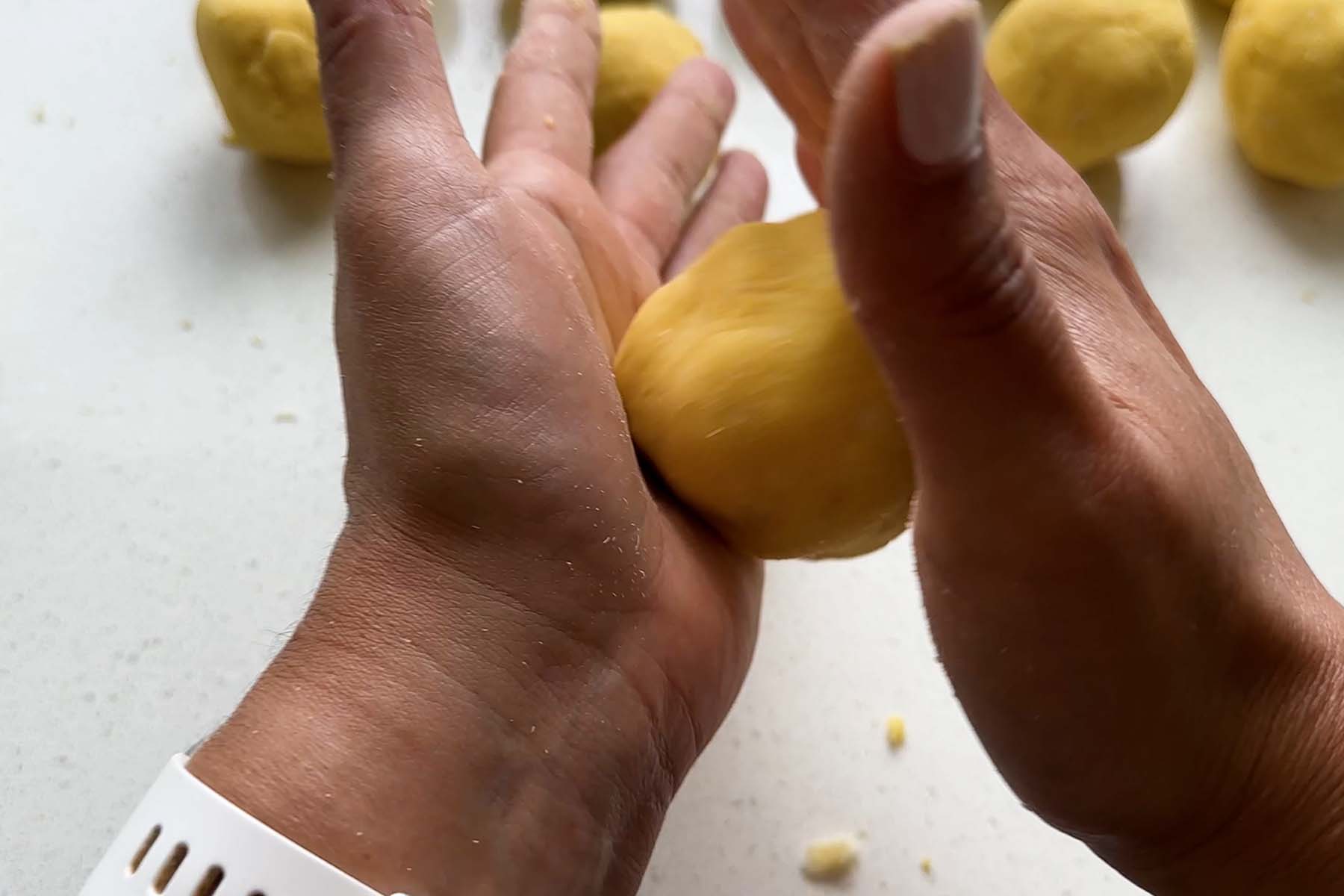 Corn dough is molded by hand.