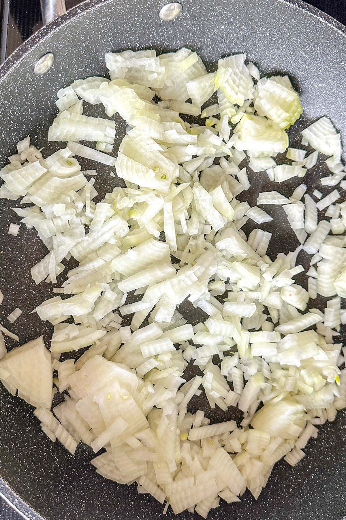 Onions frying in a skillet.