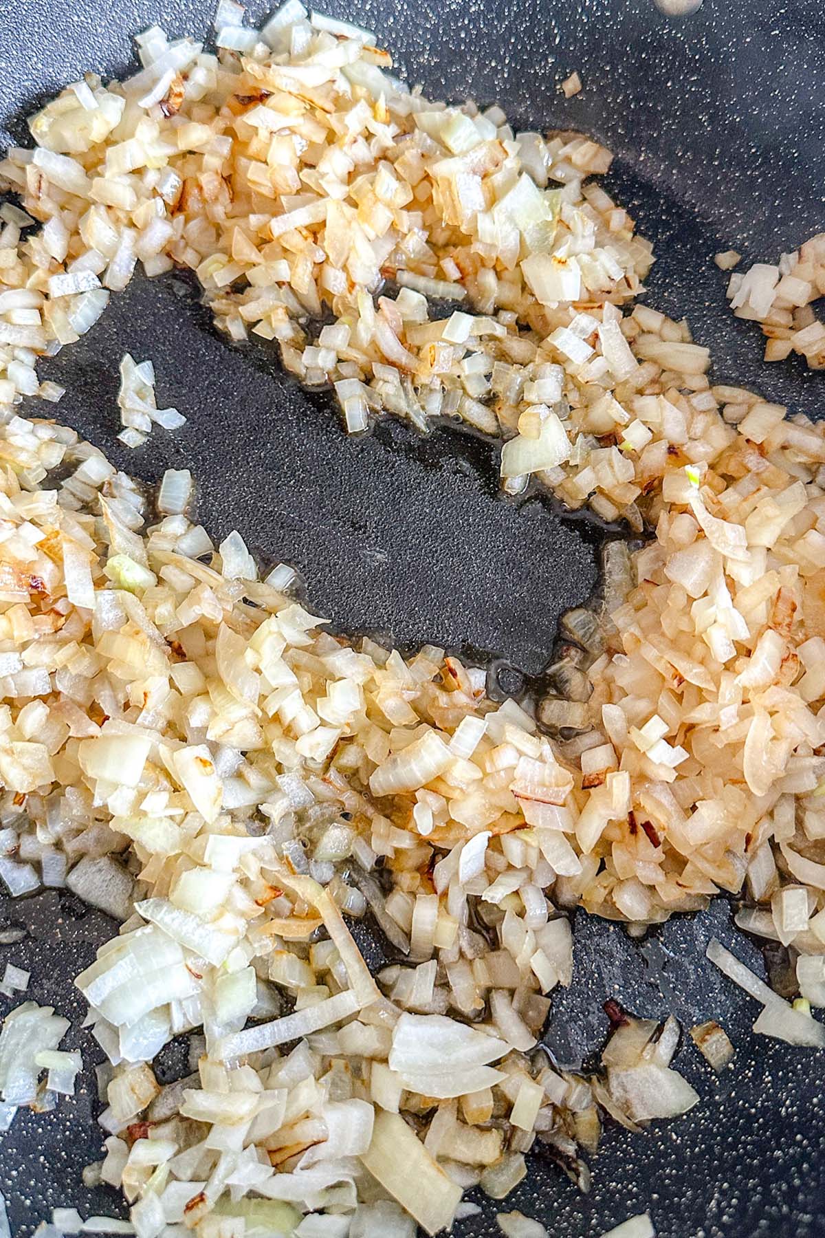 Onions frying in a skillet.