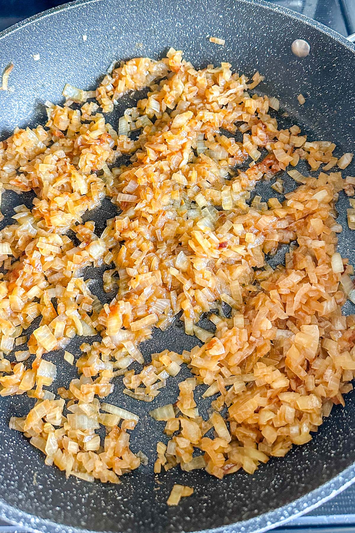 Onions frying in a skillet.