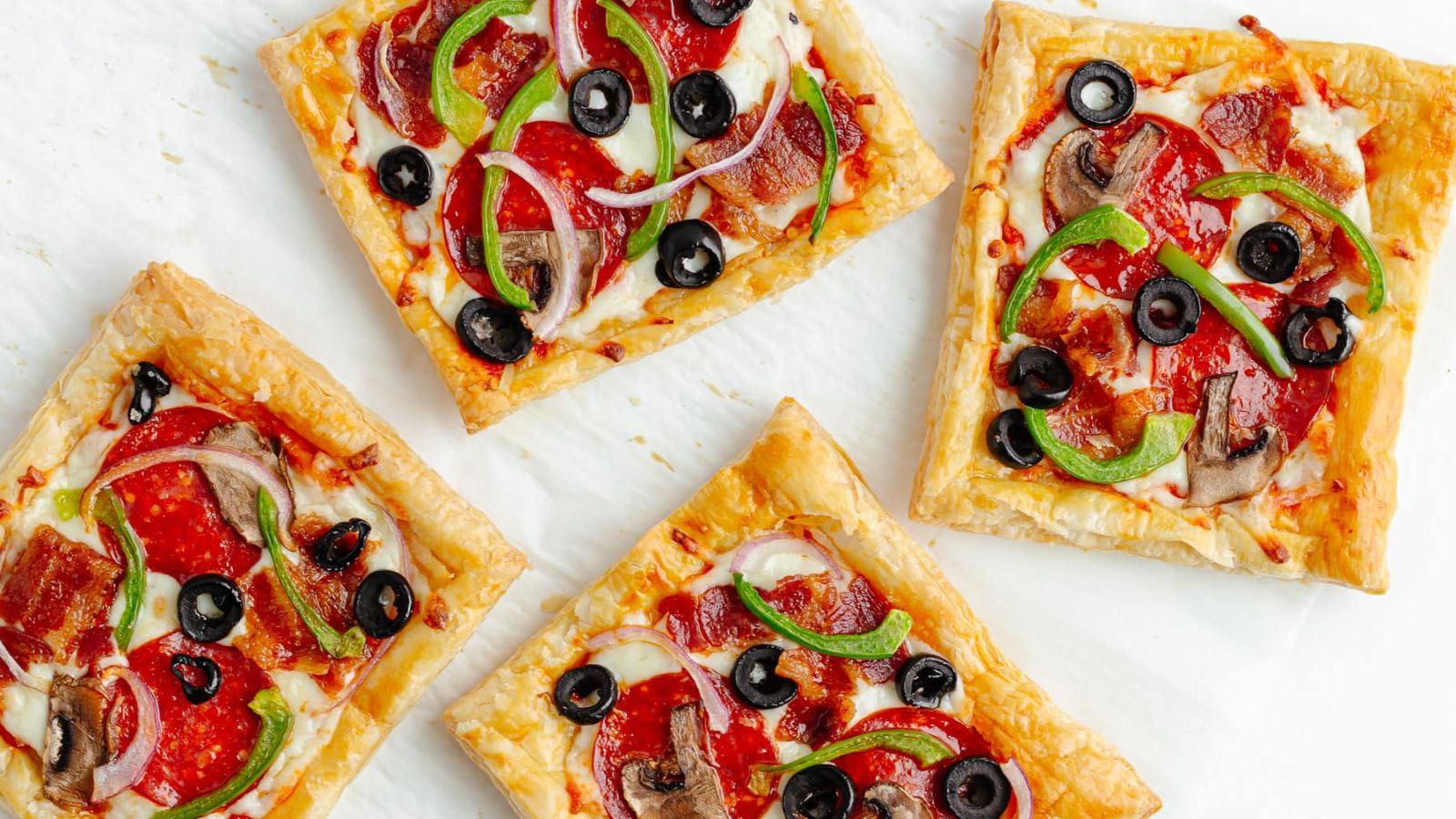 Squares of pizza made on puff pastry.