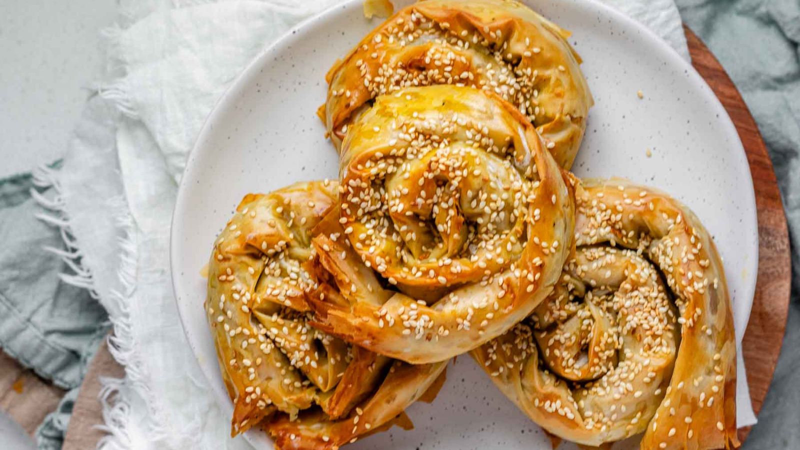 Baked golden pastry swirls topped with sesame seeds.