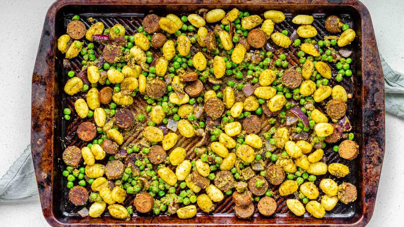 Gnocchi, peas, and sausage on a sheet pan.
