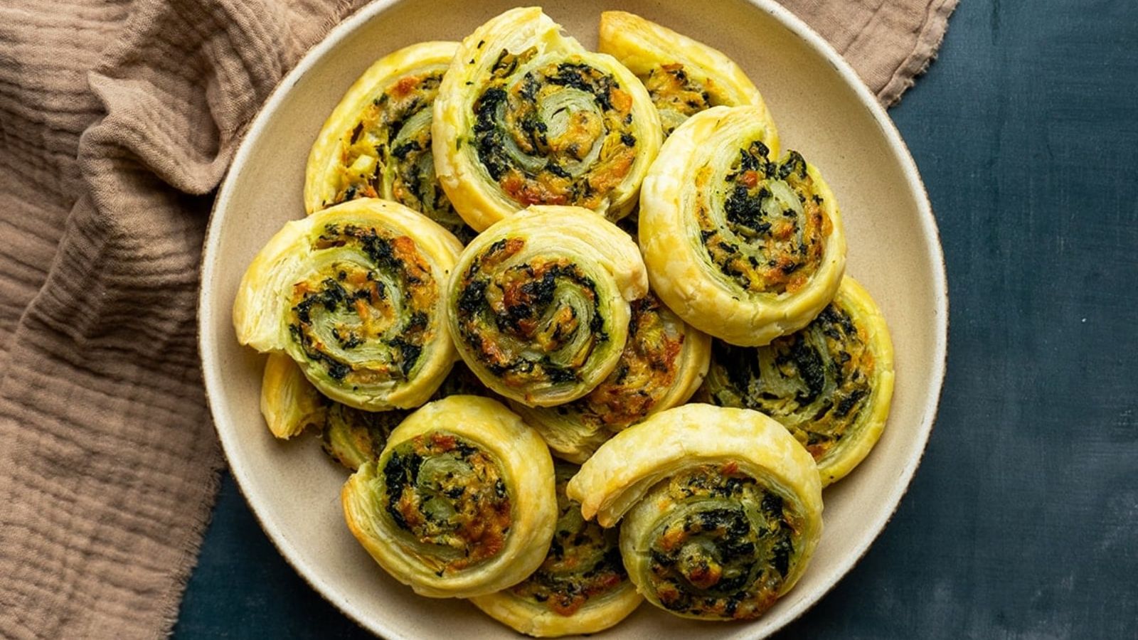 Puff pastry pinwheel appetizers on a plate.