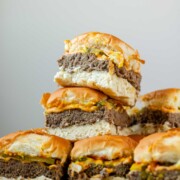 Mini burgers stacked in a pile.