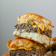 Mini burgers stacked in a pile.