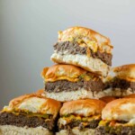 Mini burgers stacked in a pile.
