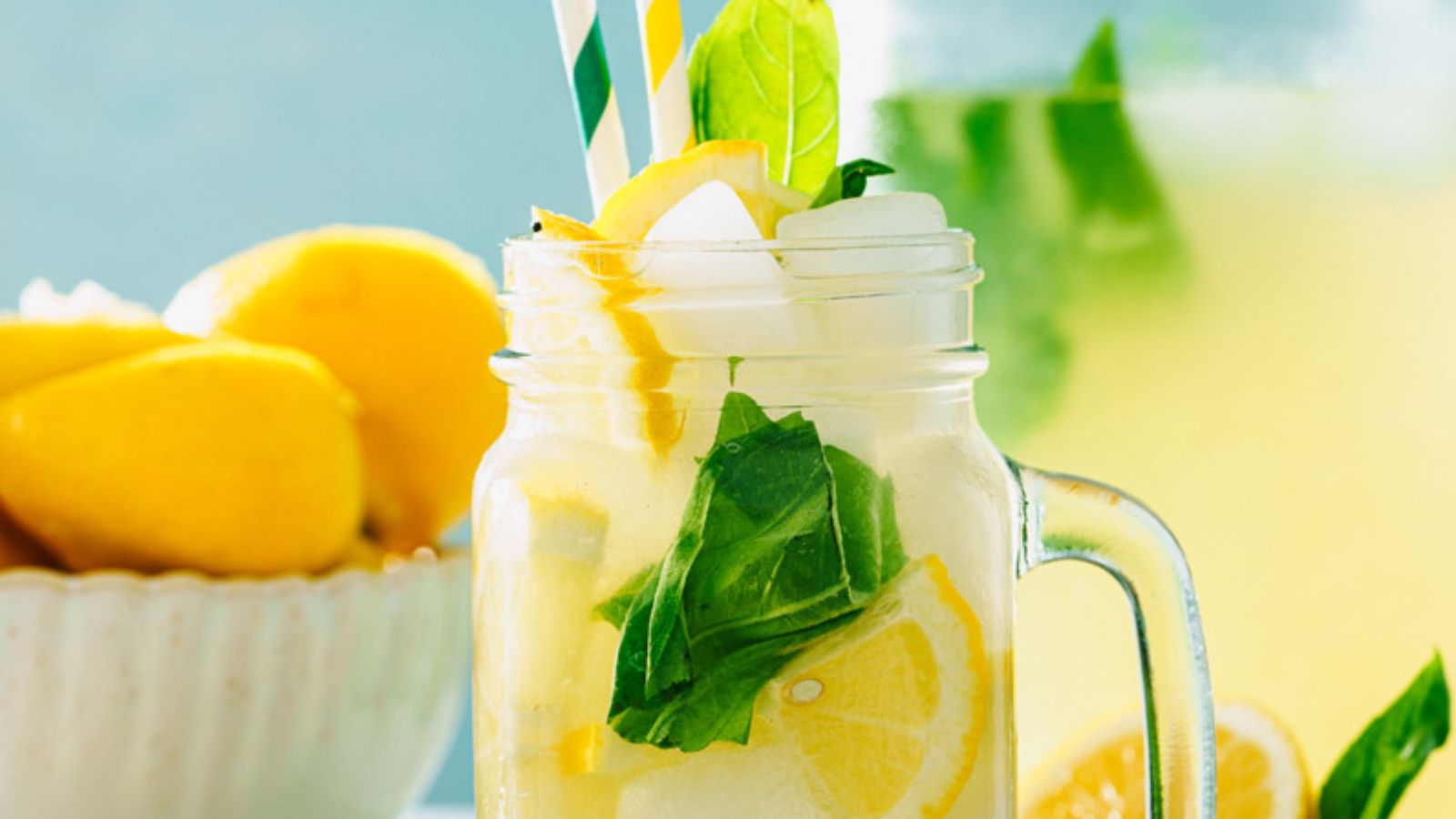Lemonade in a glass with ice and basil.