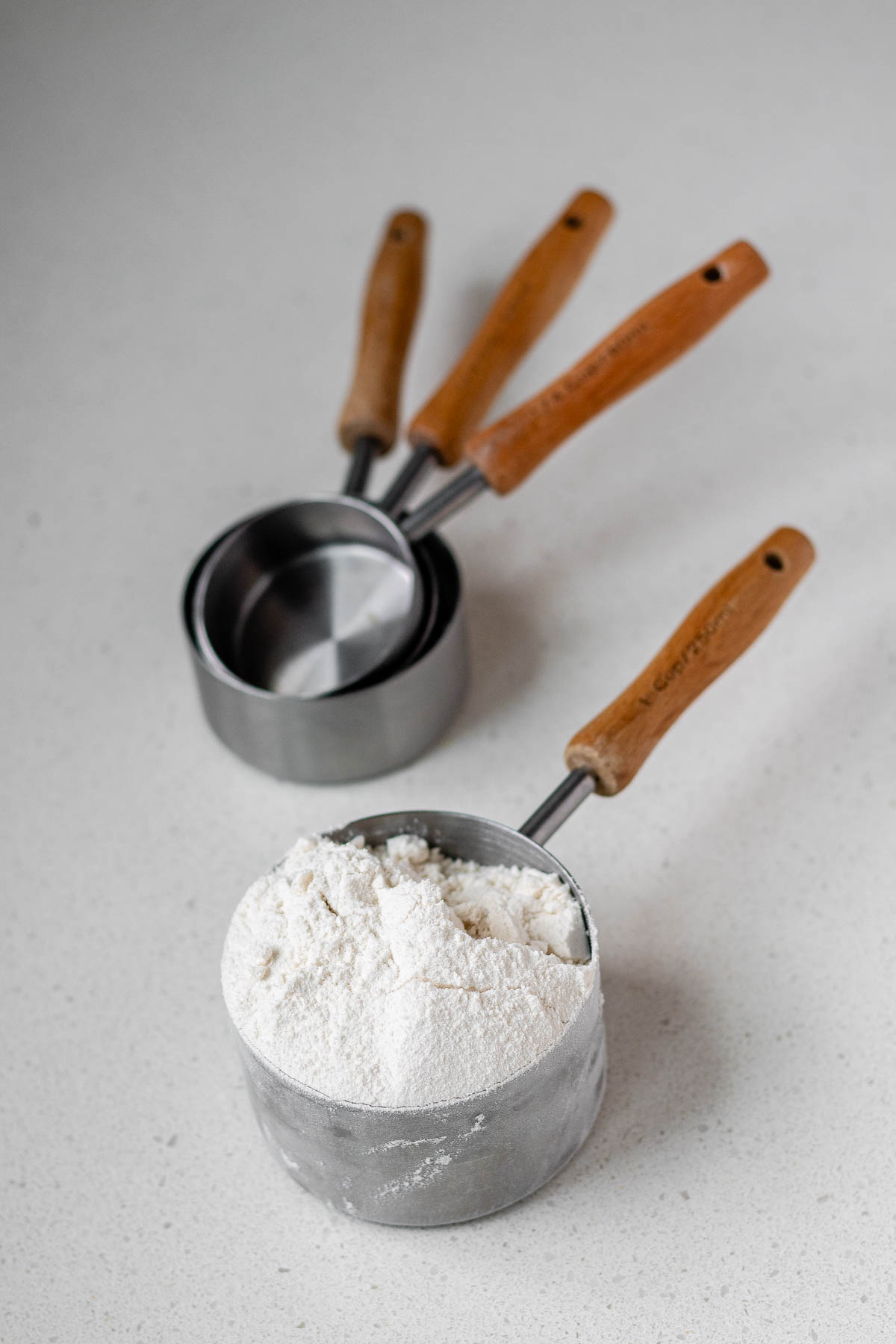 A measuring cup with flour in it.