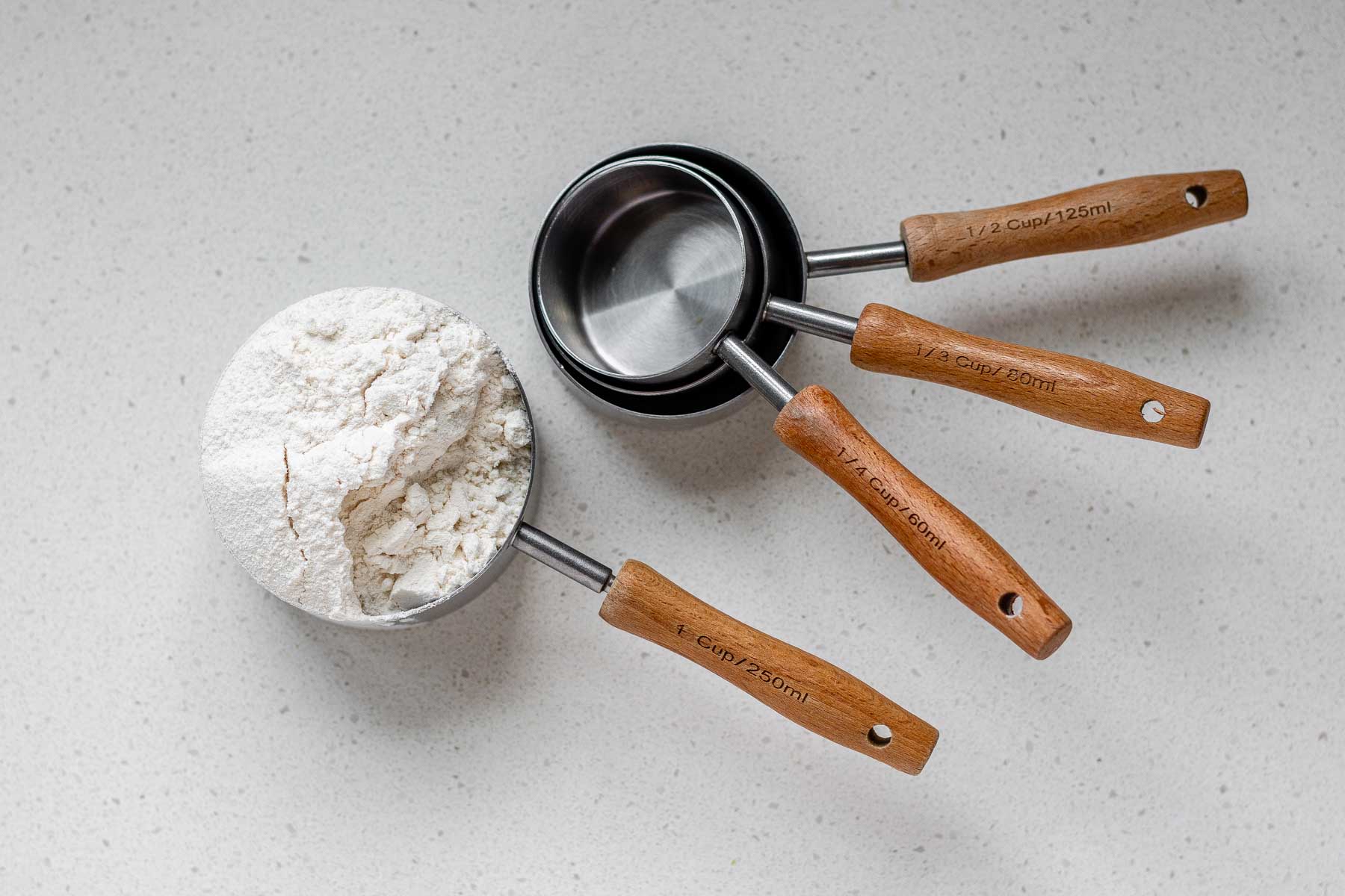 A measuring cup with flour in it.