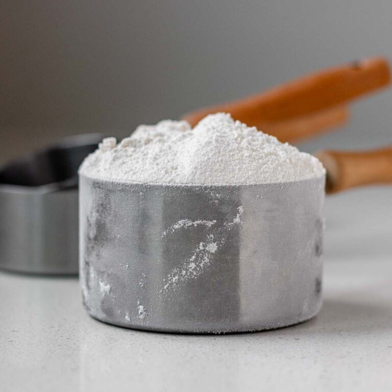 A measuring cup with flour in it.