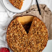Cake with peaches inside and crumbled oats on top.