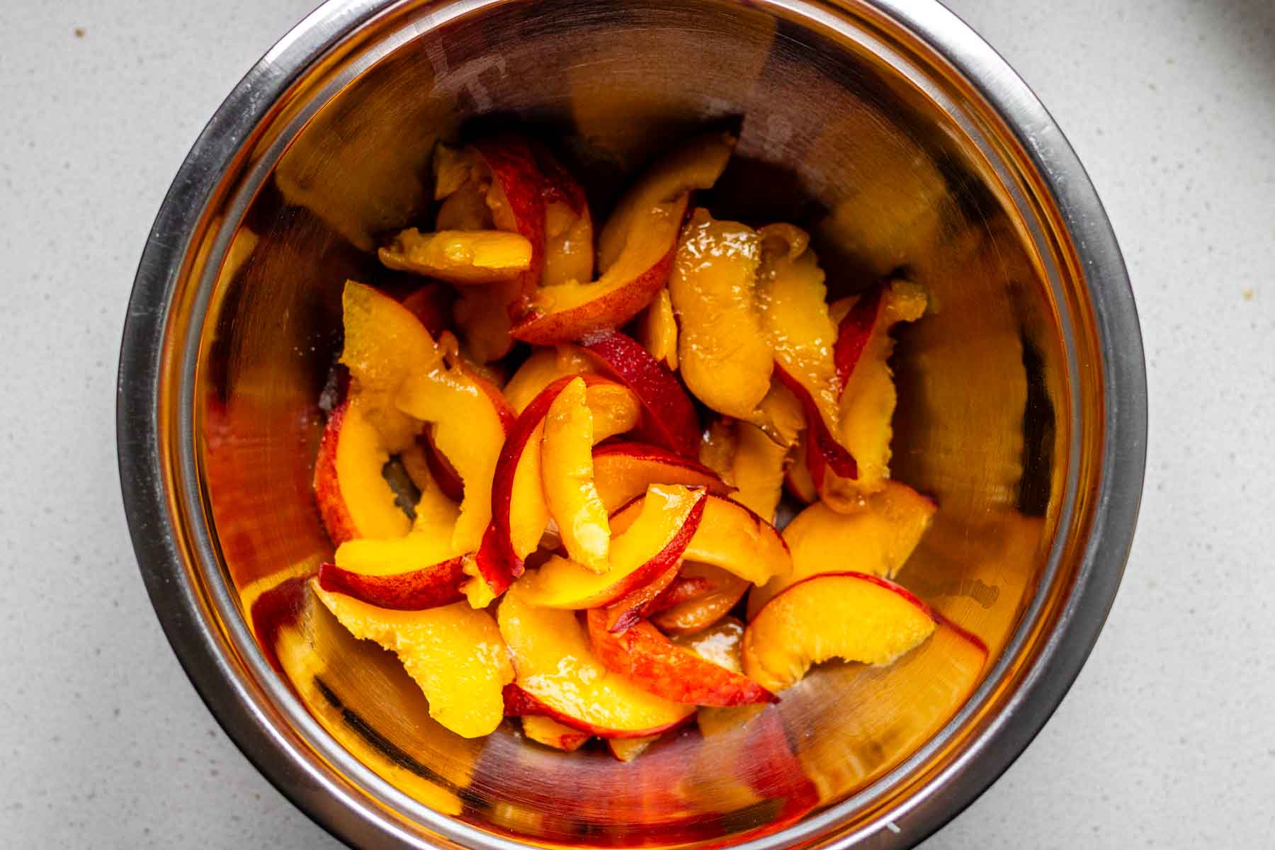 A bowl with peach slices.