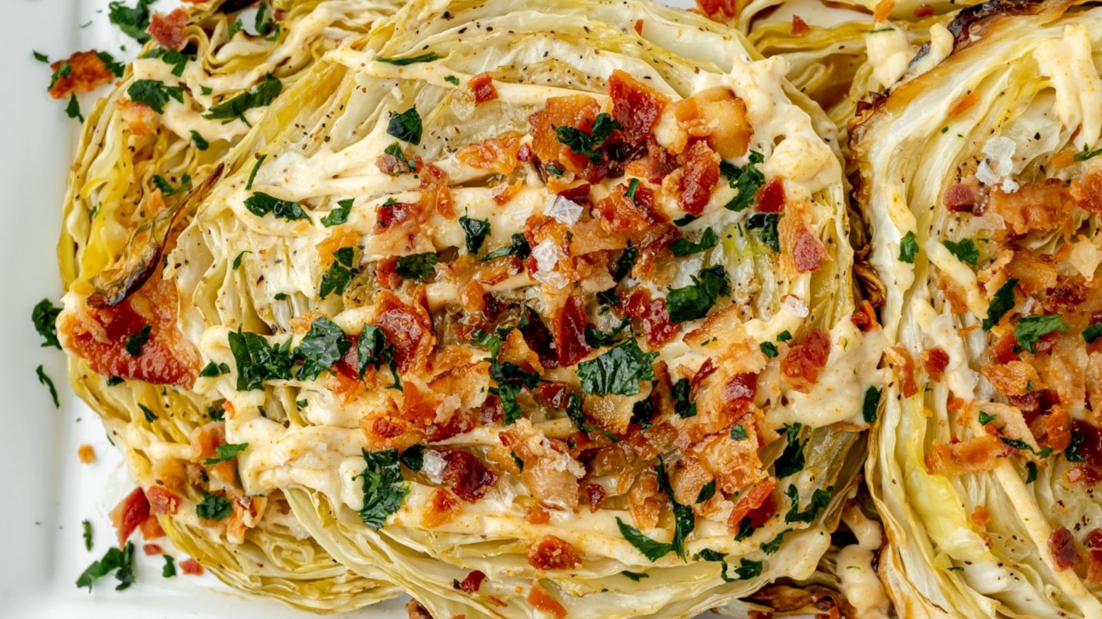 Cabbage slices topped with green and fried bacon bits.