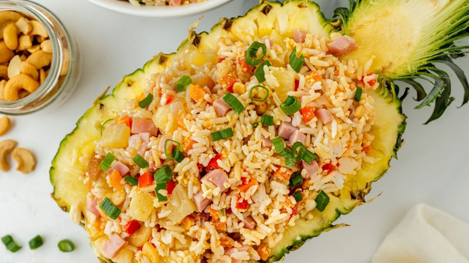 A fried rice dish in a pineapple half.