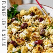 A large serving bowl with roasted cauliflower, black olives, lentils, feta cheese, slivered almonds, and fresh parsley with the text cauliflower lentil salad.