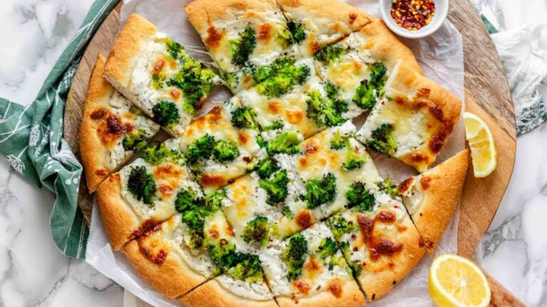 A pizza topped with broccoli.