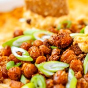 Golden baked buffalo chickpea dip fresh from the oven with melted cheese and pan-fried crispy chickpeas on top.