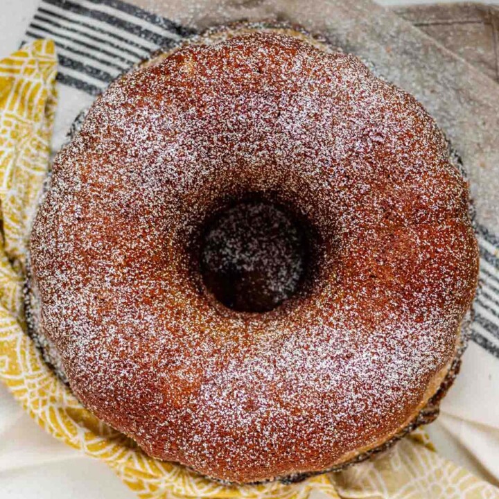 A round bundt cake topped with powdered sugar.