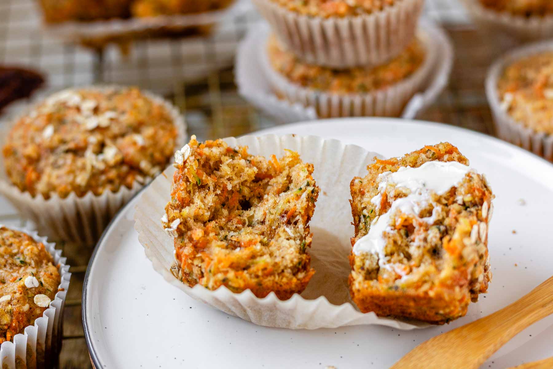 A halved muffin with butter on one half.