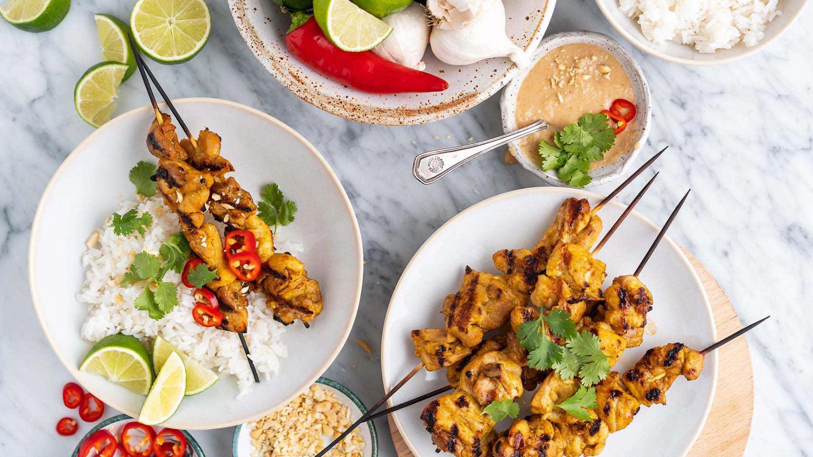 Plates with chicken skewers and rice.