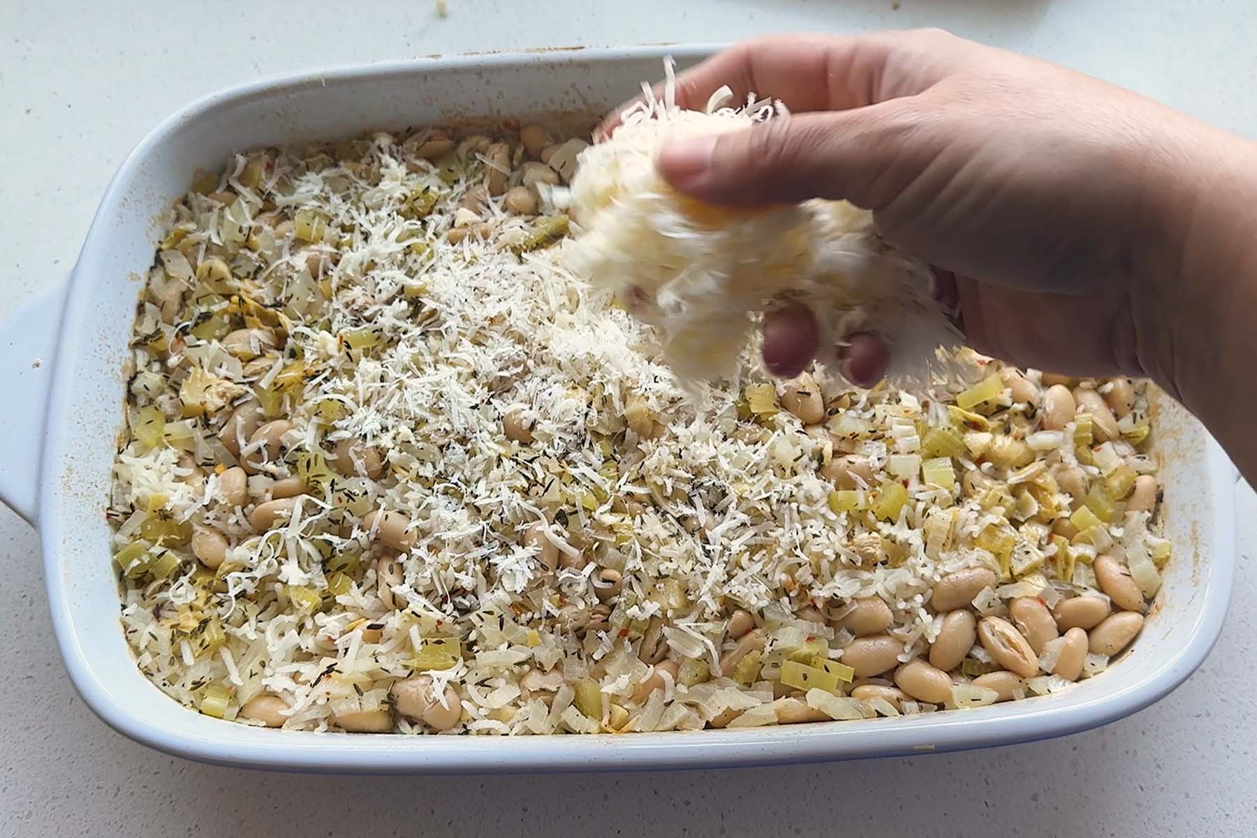 Cheese added on top of an artichoke casserole.