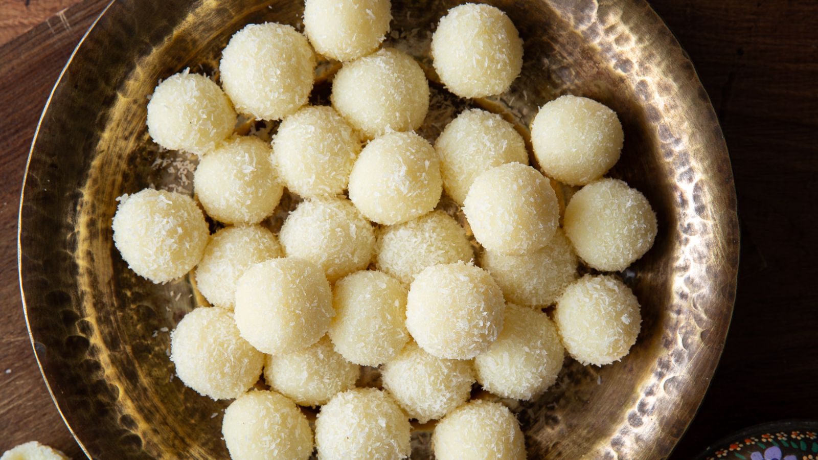 Coconut ladoo in a bowl.