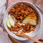 Yogurt, granola, and apples in a bowl.