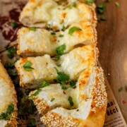 Boat-shaped baked dough filled with melted cheese.