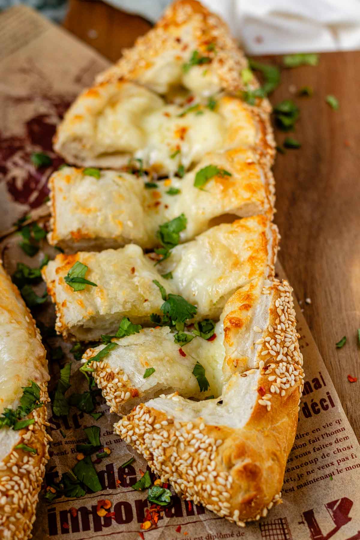Boat-shaped baked dough filled with melted cheese.