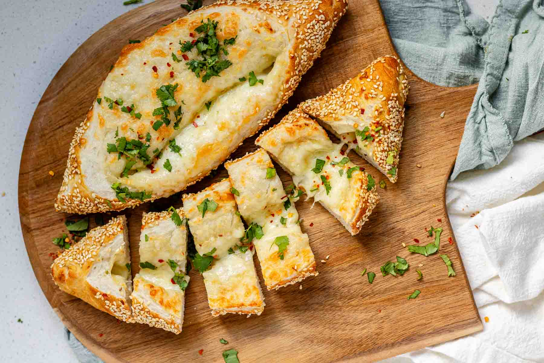 Boat-shaped baked dough filled with melted cheese.